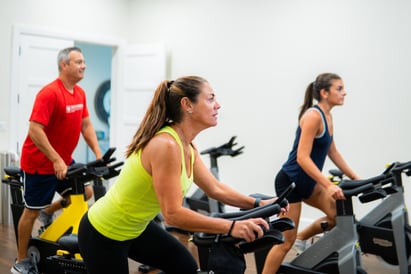 women and men group cycle class