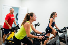 women and men group cycle class